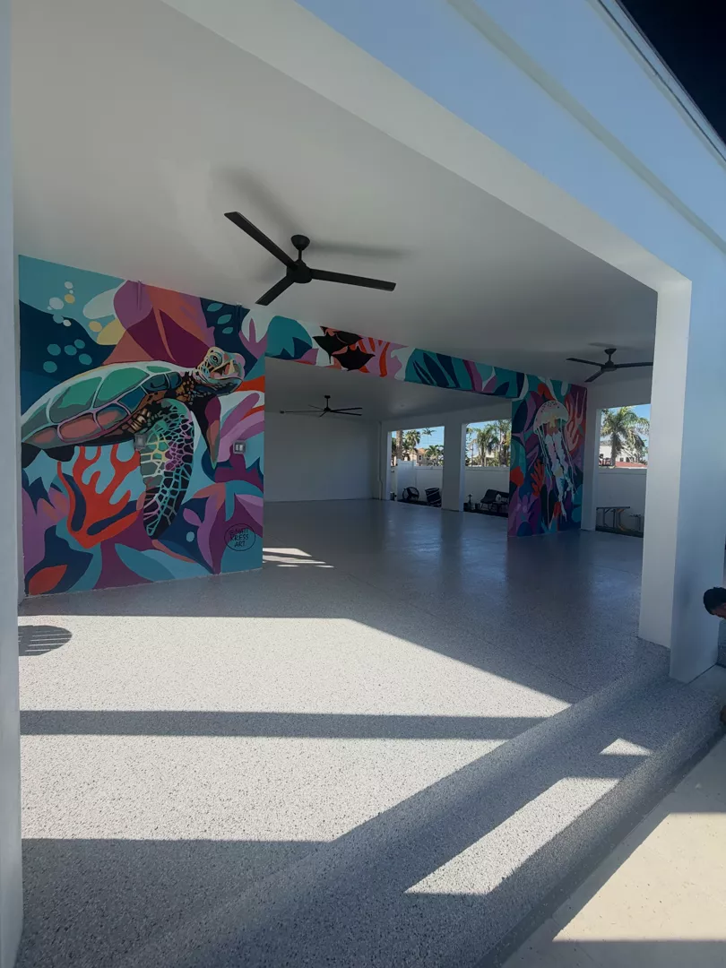 Gray decorative flake floor in a covered space with colorful sea life murals